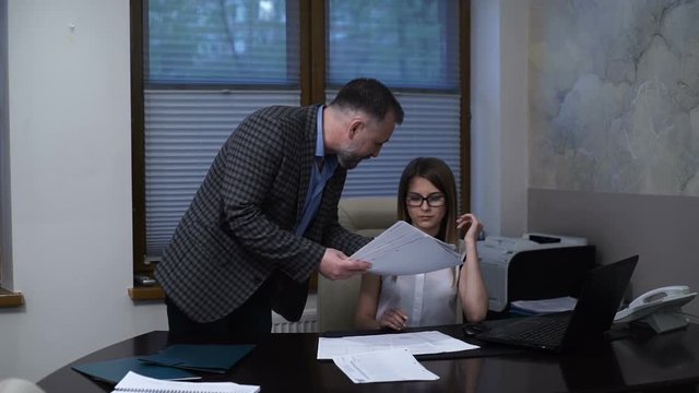 Angry boss scolds the employee, accuses an error in the report, poor performance, accuses of incompetence
