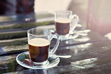 two espresso cups on a dark wooden table. Morning coffee.