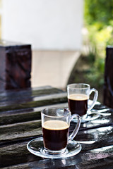 two espresso cups on a dark wooden table. Morning coffee.