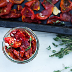 Sun dried tomatoes with herbs and sea salt in olive oil in a glass jar