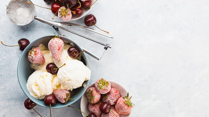 Vanilla ice cream in a grey bowl. Homemade organic dessert with jam, sweet cherry and strawberry. Top view