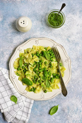 Farfalle pasta with pesto sauce and green pea.Top view.