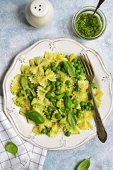 Farfalle pasta with pesto sauce and green pea.Top view.