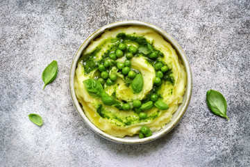 Mashed potato with pesto sauce and sweet pea.Top view.