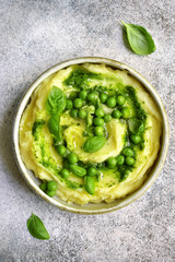 Mashed potato with pesto sauce and sweet pea.Top view.