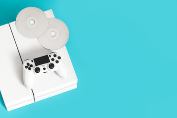 console games, remote control, discs with games, on a blue background, play computer games, entertainment, virtual world, flat lay © Mariia Petrakova