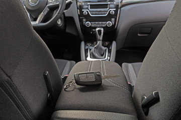 Fototapeta na wymiar key lies inside the car's interior on the armrest