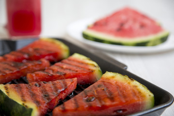 Grilled watermelon in grilling pan, closeup. Selective focus.