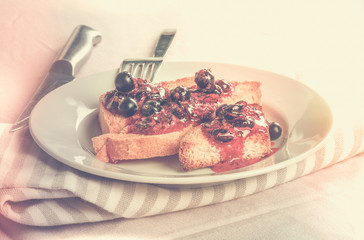 Delicious toasts bread with homemade currant jam with fork and k