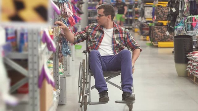 Portrait of a man with a disability wearing of a wheelchair in the Mall