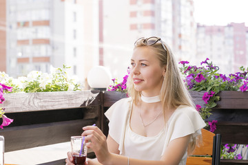 Blond woman drinking smoothies.