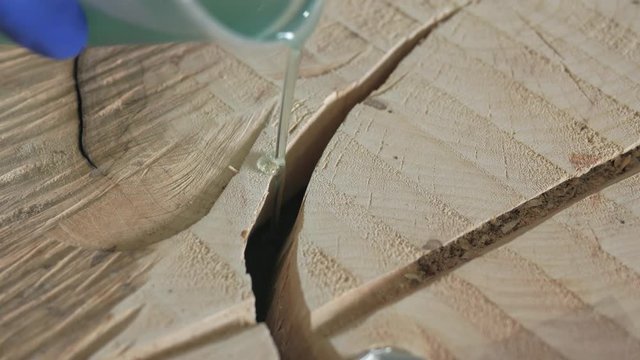 The woodworker pours the table top with epoxy resin. 4k