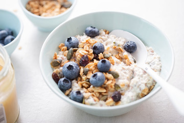 Oats with granola, dried cranberries, pumpkin seeds and blueberries 