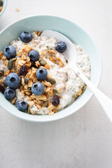 Oats with granola, dried cranberries, pumpkin seeds and blueberries 