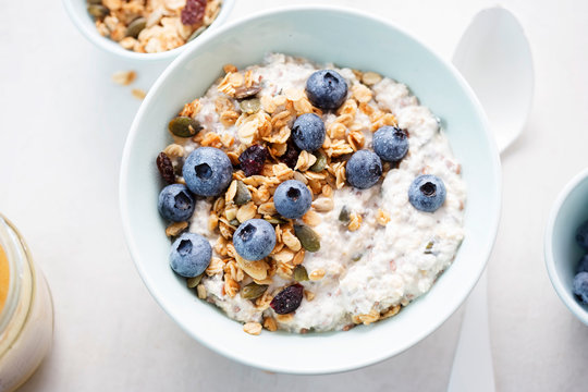 Oats with granola, dried cranberries, pumpkin seeds and blueberries 