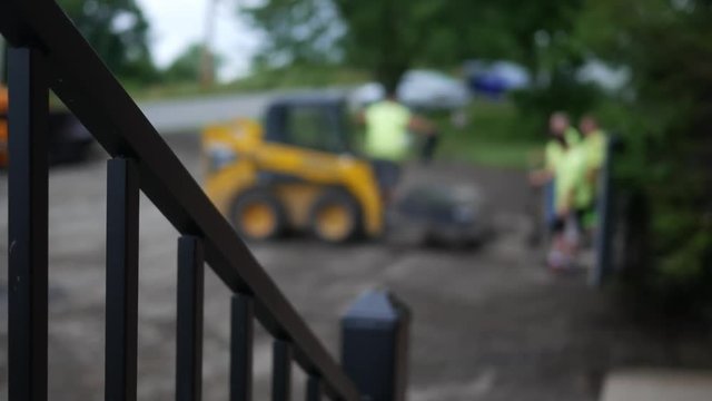 Defocused construction crew near a construction project with foreground stairwell