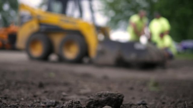 Defocused construction crew near a construction project