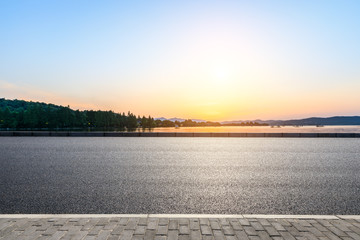 Empty asphalt road and hills silhouette at sunset © ABCDstock