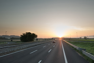 Fototapeta premium Highway travel background, motorway towards sun