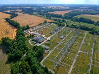 High voltage energy transformer station in forest, aerial view