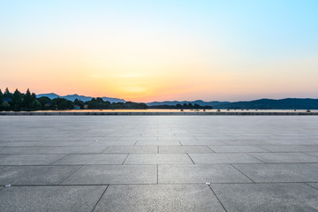Empty square floor and hill silhouette at dusk