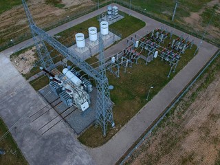 High voltage energy transformer station in forest, aerial view