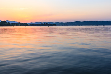 Beautiful lake and hill landscape at sunset