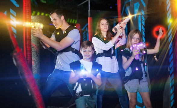 Kids And Parents In Beams During Laser Tag Game