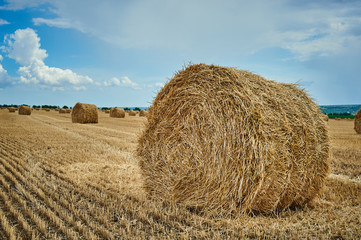 Hay bale field and beautiful blue sky