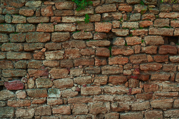 Ancient stone wall. Yellow grunge texture of old brick.