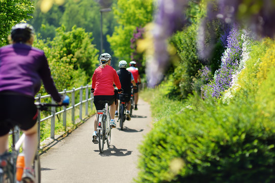 Group Of Sportive Man Cycling In Sunny Park In Hot Summer Day. Switzerland, Europe