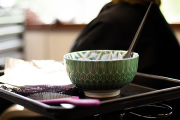 Blonde woman receiving haircut at a salon. Woman with blonde highlights. Hair foils on a female client. Master stylist cutting hair