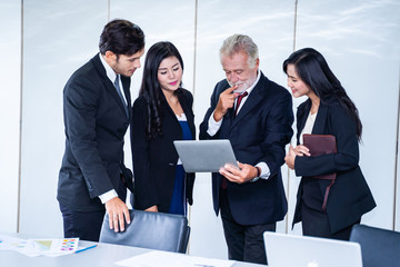 group of successful businessman. Discussion of the business profits of the company in meeting roon or conference room.