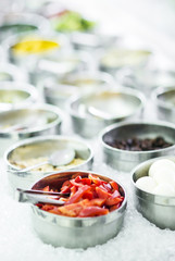 bowls of mixed fresh organic vegetables in salad bar display
