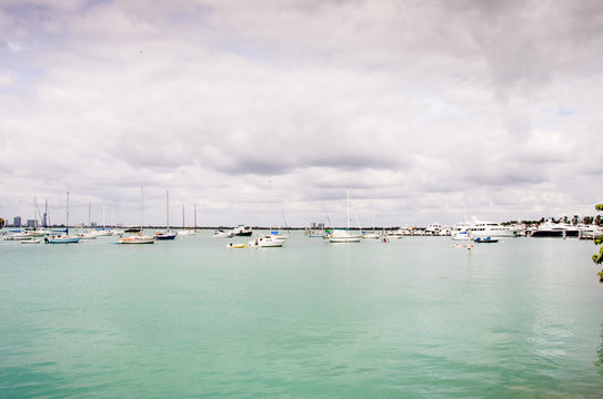 Boats on the blue water under a cludy sky