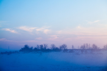 Fototapeta na wymiar Countryside winter landscape at sunset 
