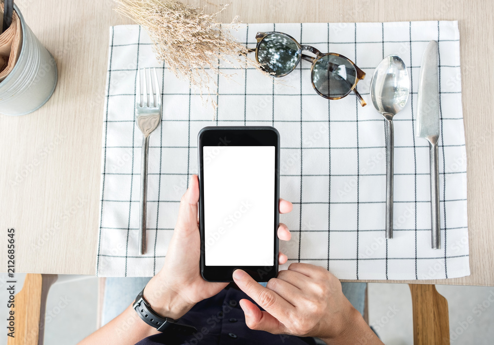 Poster woman use mobile phone apps at restaurant table.mobile payment.digital leisure lifestyle.mock up tem