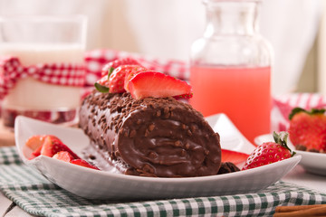 Chocolate roll with strawberries.