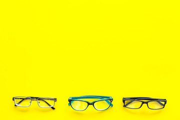 Glasses concept. Set of glasses with different eyeglass frame and transparent lenses on yellow...