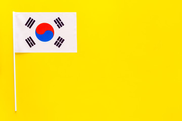 Korean flag concept. small flag on yellow background top view copy space