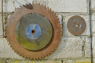 old circular saw on a brick wall