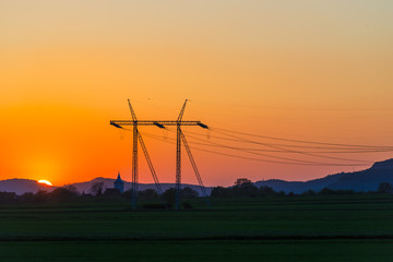 Fototapeta na wymiar Electric pylon at the sunset
