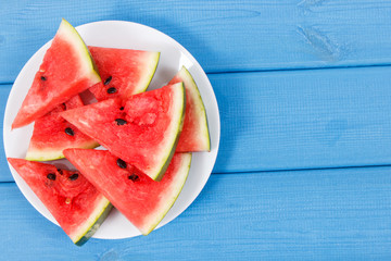 Slice of watermelon on plate, concept of healthy delicious dessert, copy space for text