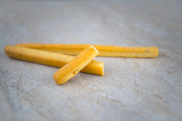 Biscuit stick on stone surface background (Selective focus)