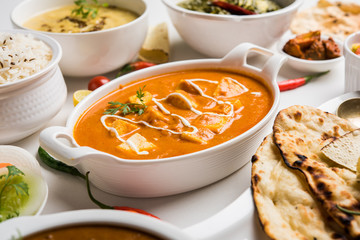 Assorted indian food for lunch or dinner, rice, lentils, paneer, dal makhani, naan, chutney, spices...