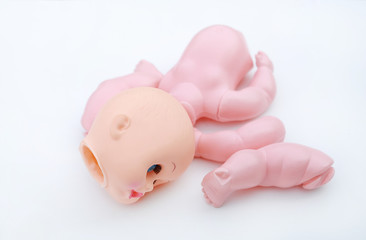 Creepy broken and naked doll isolated on white background. Separated of a doll.
