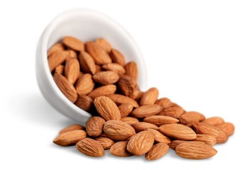 Bowl of almonds isolated on white background