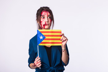 Fototapeta premium Portrait young catalan victim woman holding flag of catalonia isolated on white background with copyspace. Protest against terrorism.
