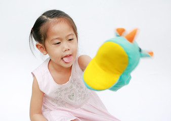 Adorable little Asian child girl hand wear and playing Rhinoceros puppets on white background.