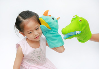 Little Asian child girl hands playing animal puppets on white background.
